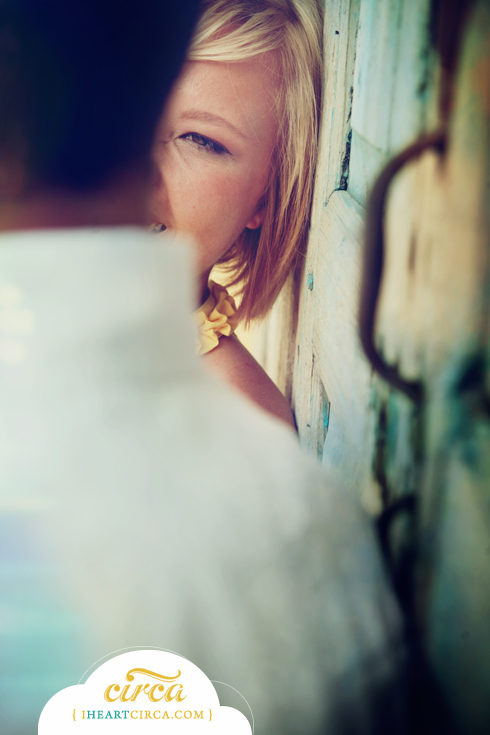 A woman peeks around a wall at her partner, smiling