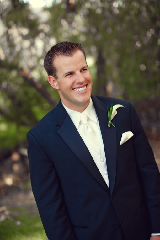 Smiling groom in black tuxedo on wedding day