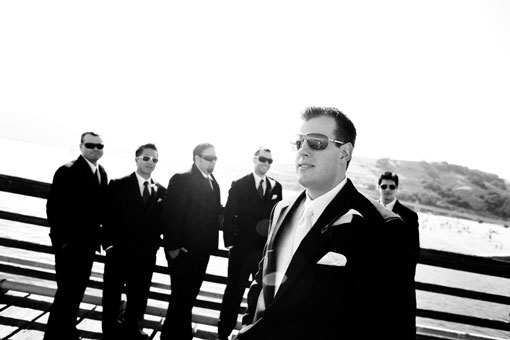 Groom and groomsmen in black suits with sunglasses