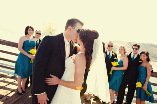 Bride and groom kissing at a pier wedding ceremony