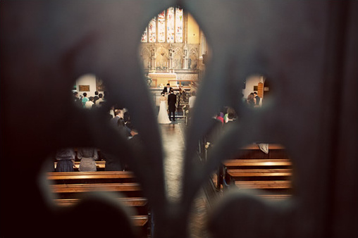 Wedding ceremony viewed through a decorative architectural frame