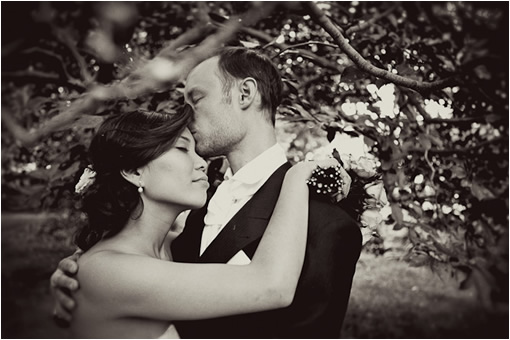Black and white photo of a bride and groom embracing