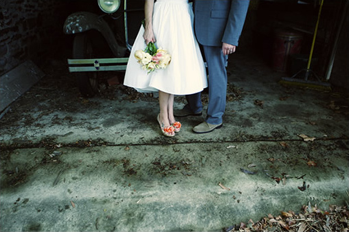 Bride and groom with vintage car in garage wedding