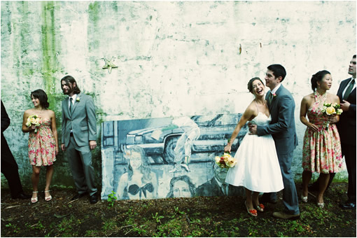 Wedding party poses by unique mural backdrop outdoor