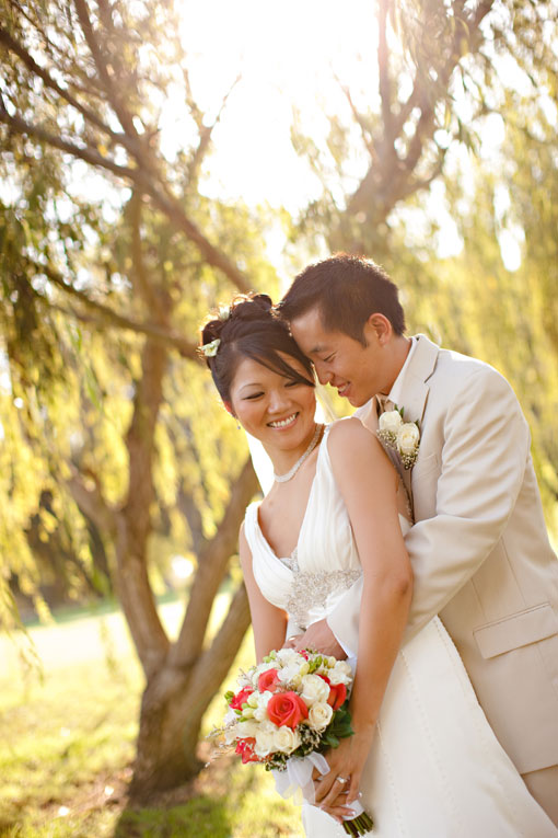 Asian couple embraces at outdoor wedding photo shoot
