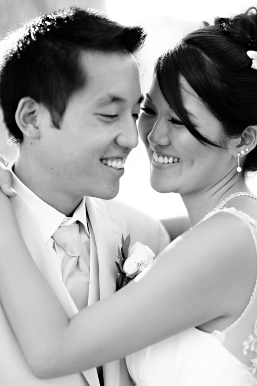 Happy Asian couple embracing on their wedding day