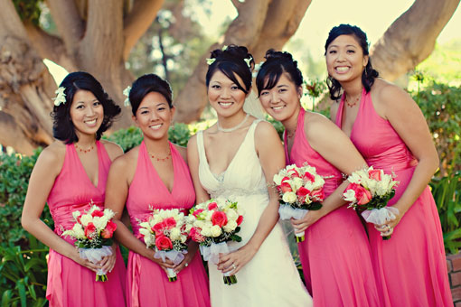 Bride and bridesmaids in pink dresses with bouquets