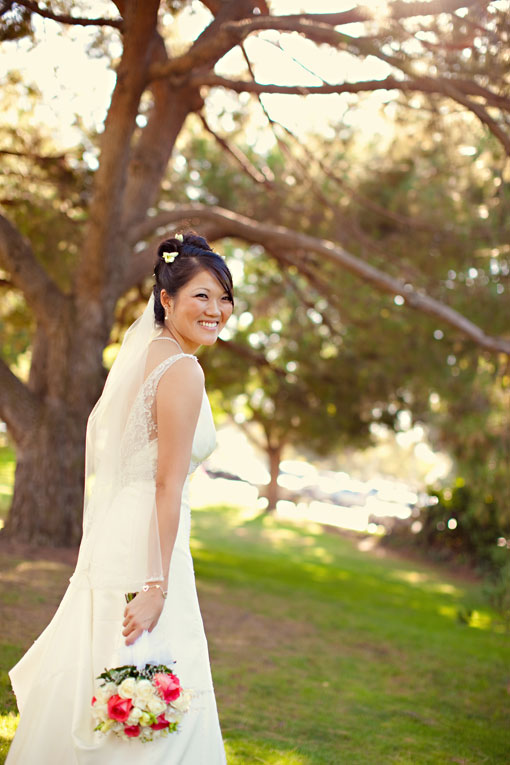 Smiling bride in a wedding dress holding a bouquet