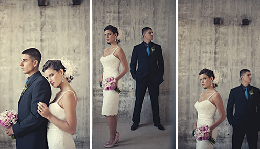Bride and groom pose against a textured gray backdrop