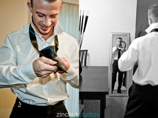 Groom tying tie reflecting in mirror on wedding day
