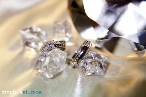 Wedding rings resting on crystal decorations