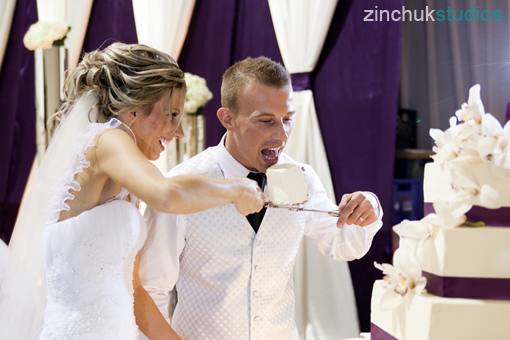 Happy bride and groom cutting wedding cake together