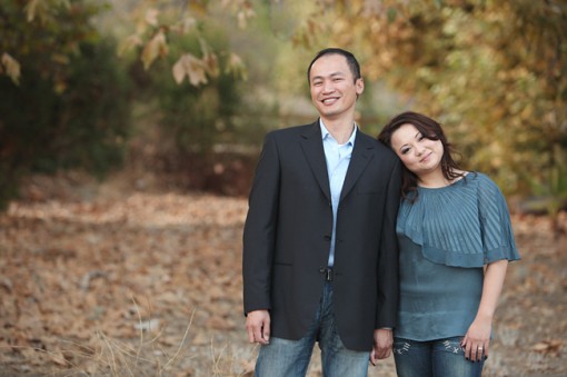 Couple posing together with nature background, looking at camera