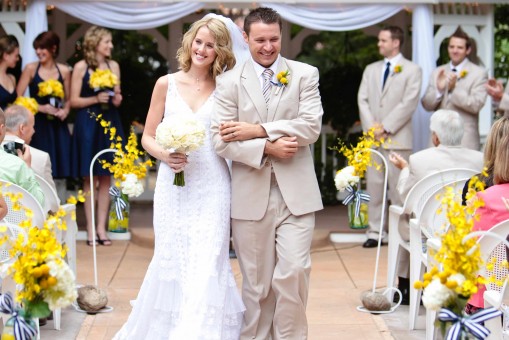 Bride and groom walking down the aisle at their wedding with joy