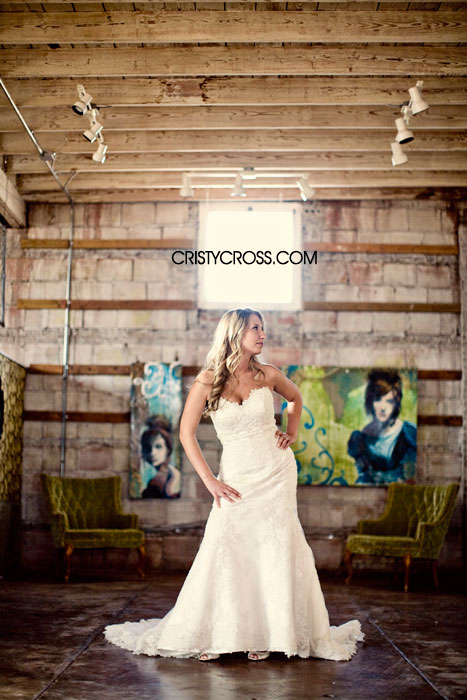 Bride in a beautiful wedding dress posing indoors with paintings