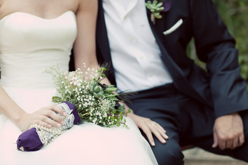 Bride and groom embrace, wedding day with bouquet details