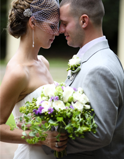 A loving couple on their wedding day, gazing at each other tenderly