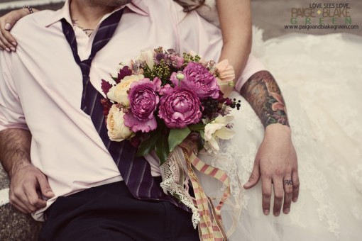 Wedding couple holding a bouquet of colorful flowers close up