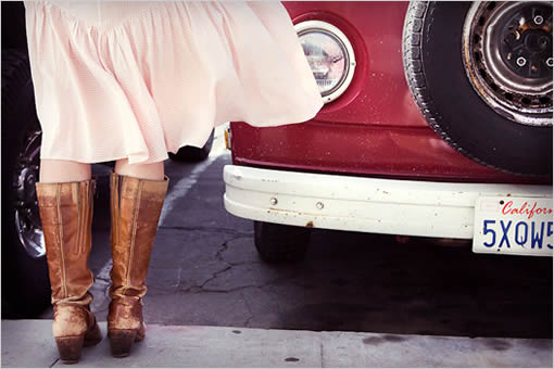 Woman in boots near a vintage red van, California vibes