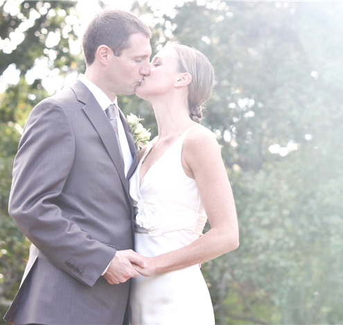 Newlyweds share a kiss, celebrating their wedding day