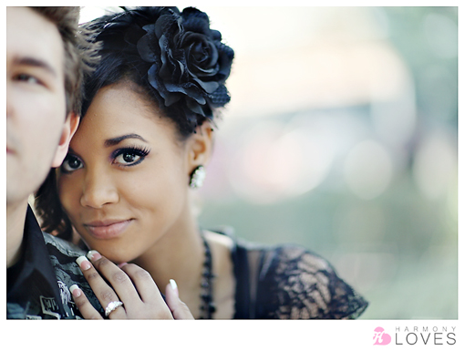 Romantic portrait of a couple with a black rose in hair