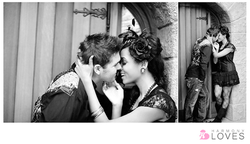 Couple embraces in a romantic pose near an old building in grayscale