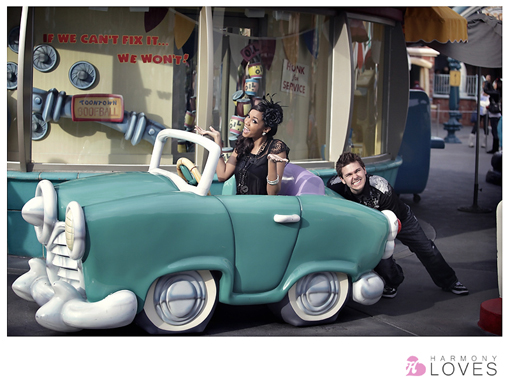 Couple poses with a cartoon car in Disneyland Toontown