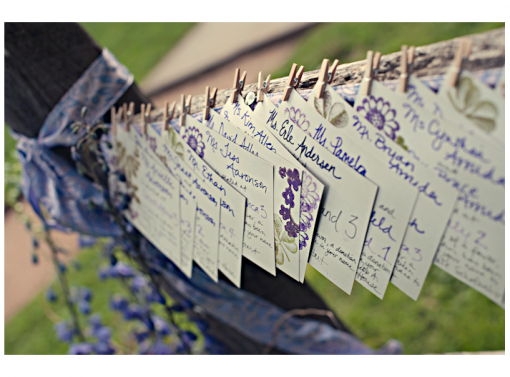 Wedding place cards hanging with clothespins, floral details