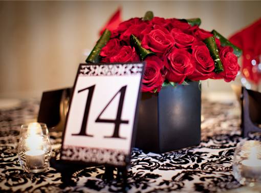 Table fourteen centerpiece with red roses and candles