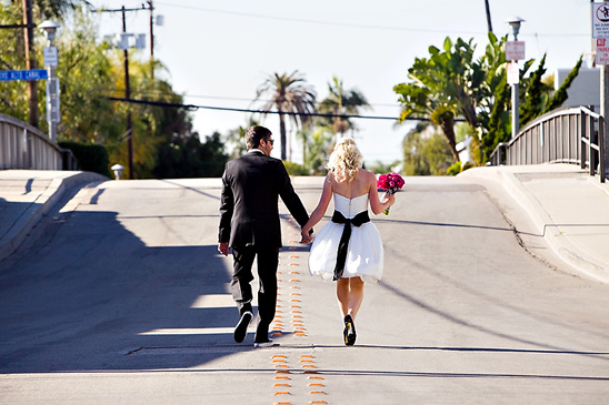 Bride and groom walking away holding hands