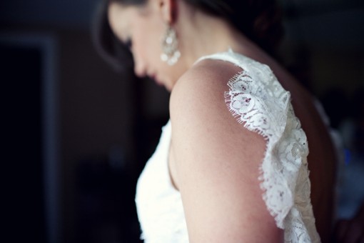 Elegant bride with lace wedding dress detail, preparing for her wedding