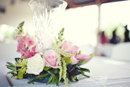 Elegant pink and white rose centerpiece in crystal vase