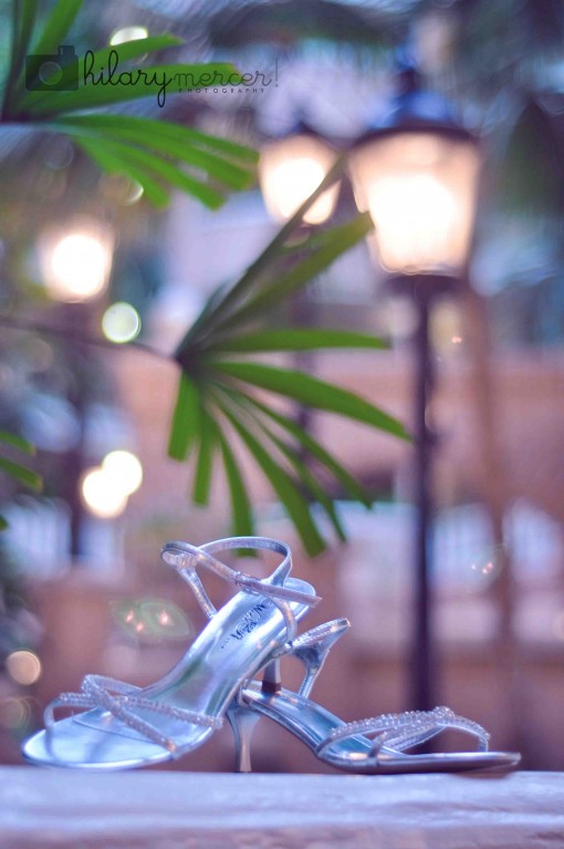 Elegant silver bridal heels near lights