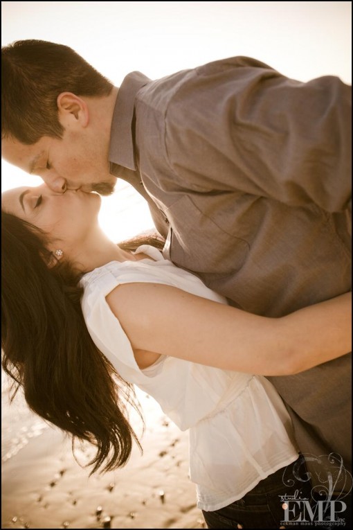 Couple kissing on the beach romantic moment