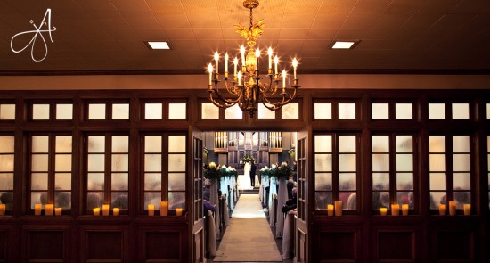 Elegant church wedding aisle with candlelight and chandelier