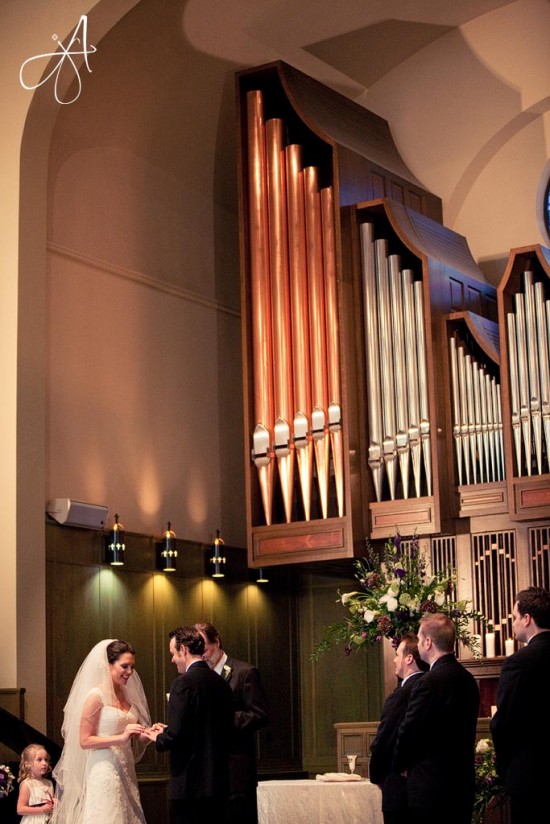 Bride and groom exchanging rings at church wedding