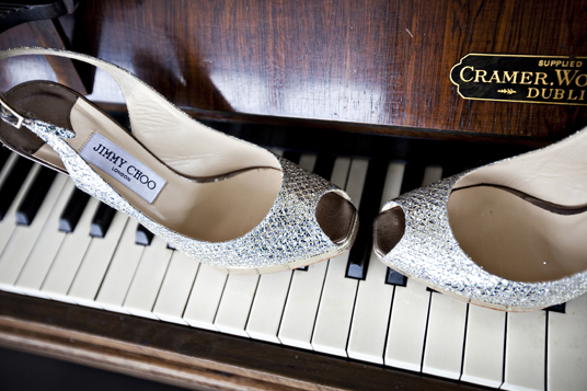 Jimmy Choo sparkling heels on piano keys for elegant style