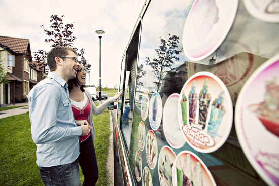 Couple looking at ice cream sundae choices on a van