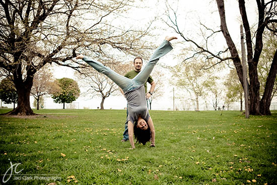 Happy couple doing a handstand in a park, perfect for spring fun