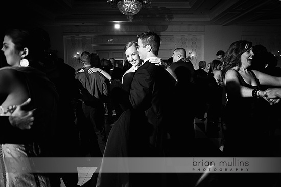 Wedding guests dancing and celebrating at reception in black and white
