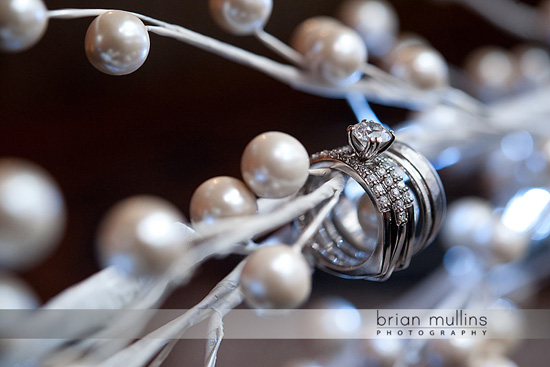 Wedding rings with diamonds on a pearl garland display