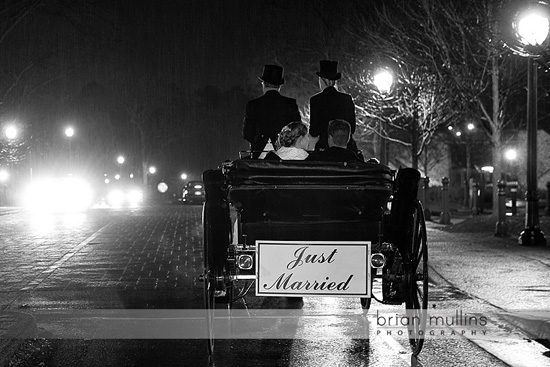 Just married couple riding in a horse carriage at night