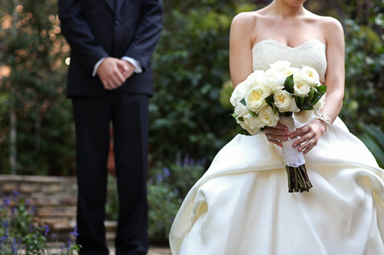 Bride holding flowers waiting for groom at a beautiful wedding