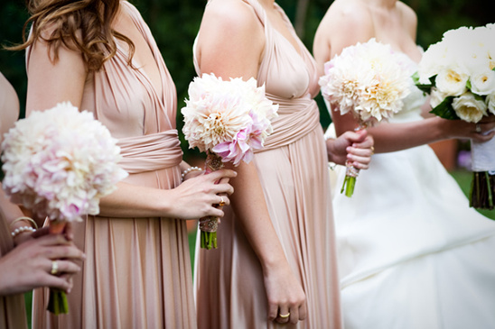 Bridesmaids holding bouquets at a garden wedding ceremony