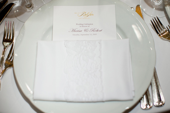 Wedding table setting with a menu and decorative napkin
