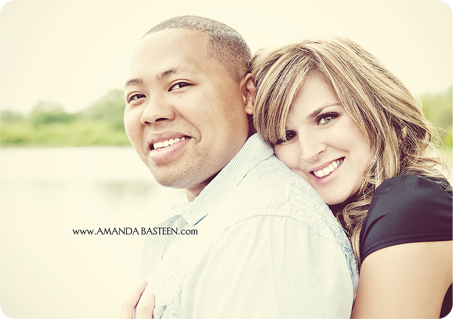 Loving couple smiling, embracing with lake background