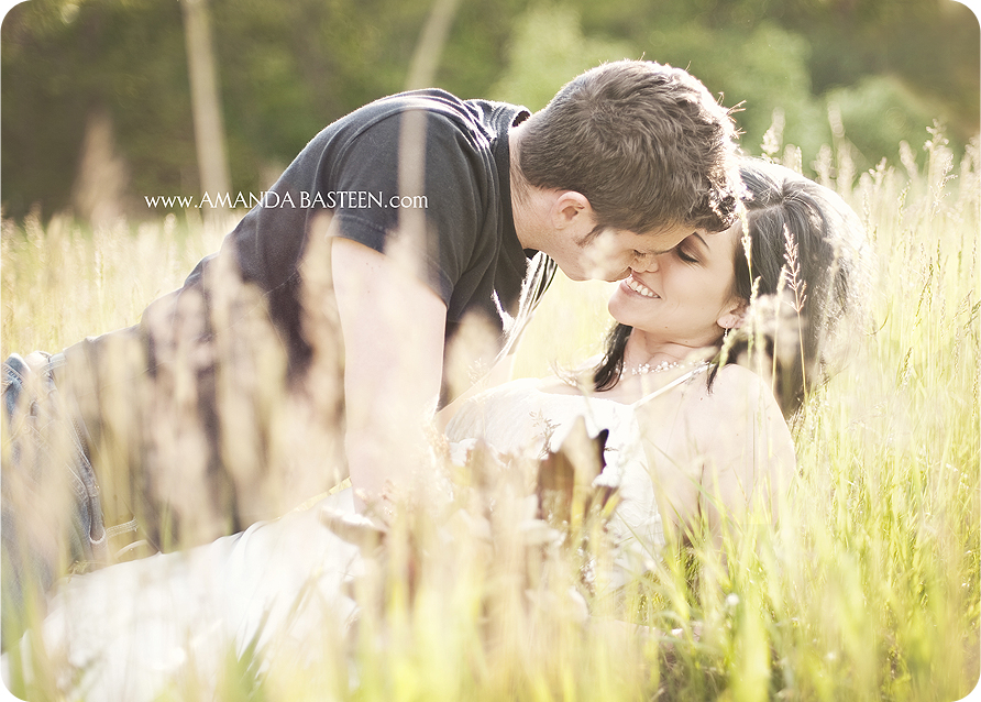 Romantic couple in a field about to kiss, embracing in love