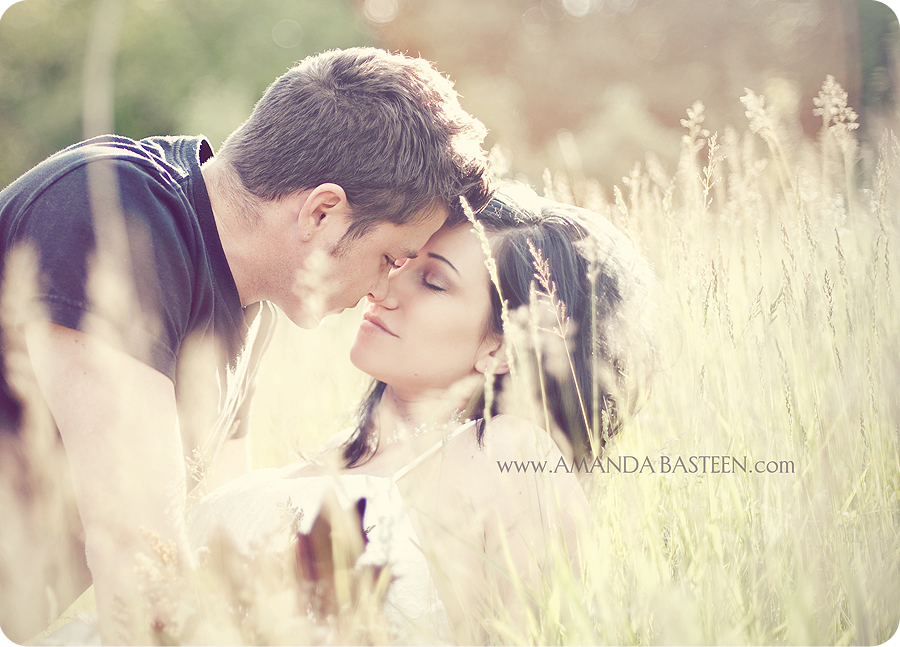 Romantic couple sharing a gentle moment in a sunlit field