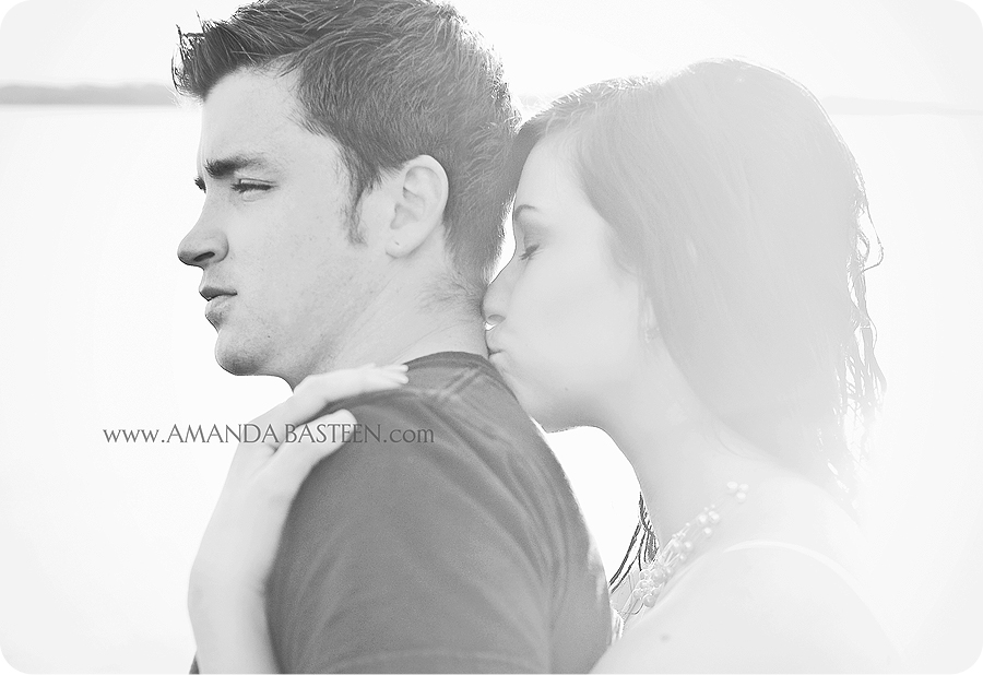 Romantic moment captured with a kiss on the neck, grayscale photo