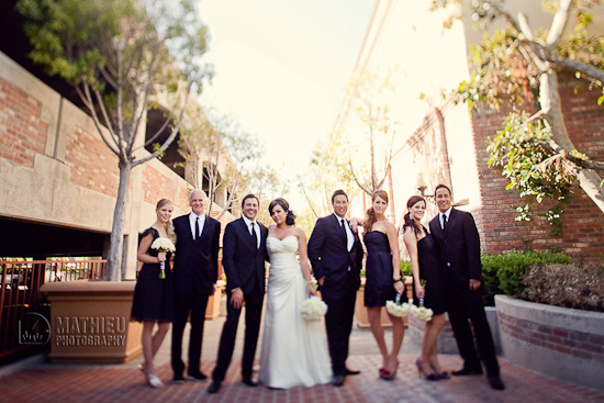 Wedding party poses for a photo with a bride and groom in the middle